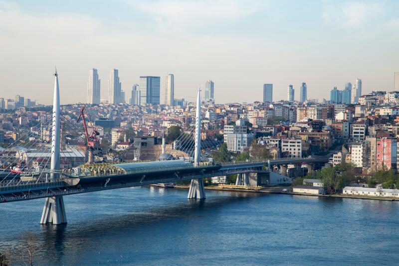 Golden Horn Metro Bridge with old and modern side of Istanbul background view during the day time. Lots of building and sea view