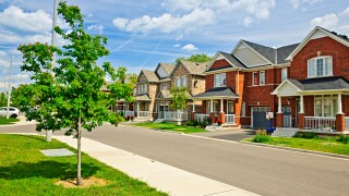 Suburban residential street with red brick houses