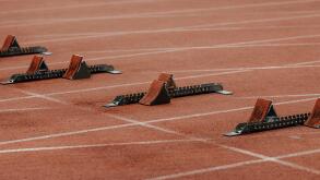 starting blocks on start line of running track stadium