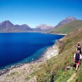 Walkers heading towards the Black Cuillin on the coastal path from Elgol, Isle of Skye, Scotland