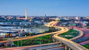 Washington, DC skyline of monuments and highways.