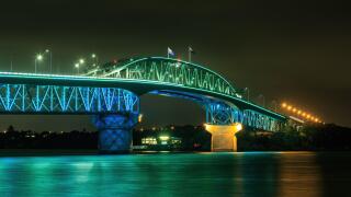 The Auckland Harbour Bridge, Auckland, New Zealand, colorfully lit at night during Auckland Anniversary