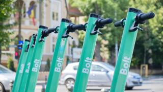 Bucharest, Romania - July 16, 2020: Bolt electric scooters parked in a row on a sidewalk. Modern ride sharing, urban transportation alternative in cit