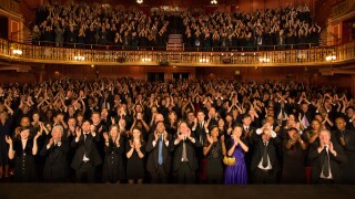 Audience applauding in theater