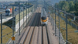 Eurostar speeds through a congested 'pinch point' with the M20 motorway and domestic rail line on the Channel Tunnel Rail Link.
