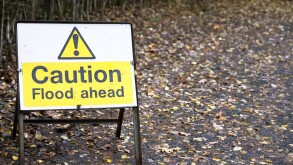 Flood ahead caution warning road sign water risk for drivers