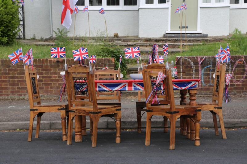 Wooden Table And Chairs Decorated With Union Jack Flags Ready For Street Party Celebrating The Queen's Diamond Jubilee