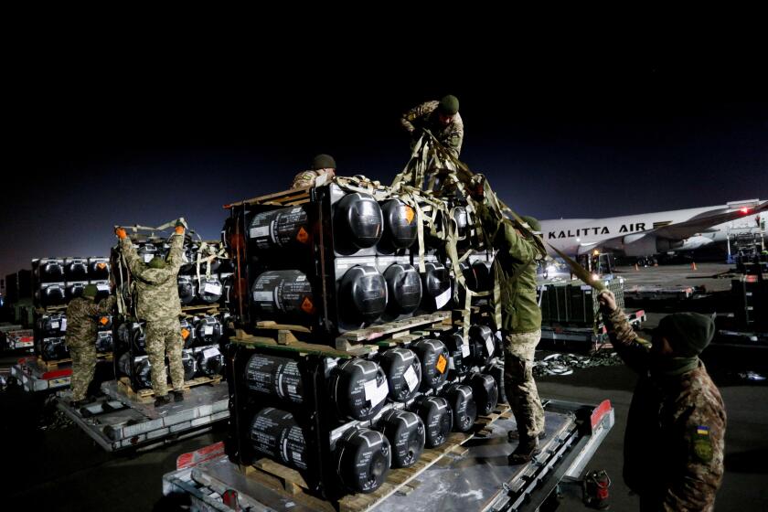 Ukrainian service members unpack Javelin anti-tank missiles, delivered by plane as part of the U.S. military support package for Ukraine, at the Boryspil International Airport outside Kyiv, Ukraine February 10, 2022. REUTERS/Valentyn Ogirenko