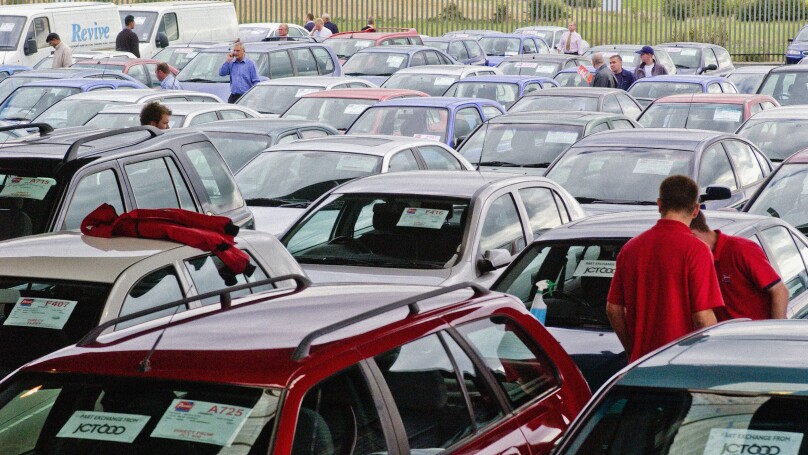Buyers inspecting cars at a UK car auction
