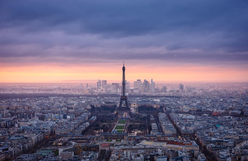 Paris cityscape clad in pink at dusk. Aerial view of Paris and the Eiffel Tower, Champ de Mars, Trocadero and La Defense