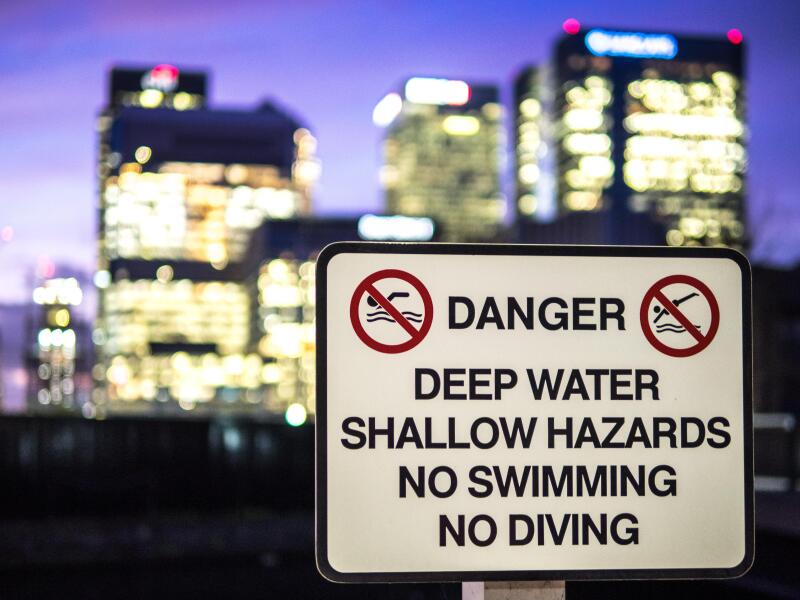 Danger Sign in front of London Banks at the dockside Canary Wharf