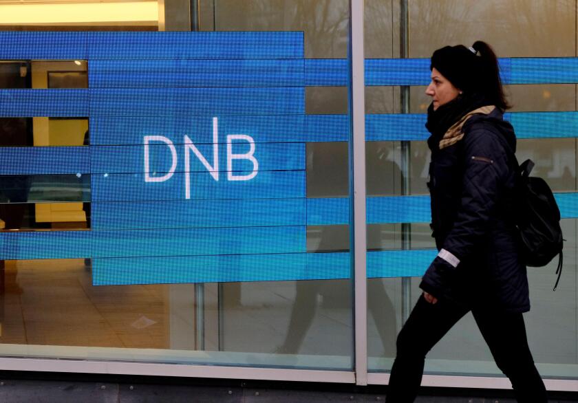 A woman walks past DNB bank branch in Stavanger, Norway December 5, 2019. REUTERS/Ints Kalnins