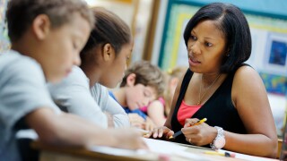 Elementary school teacher with students