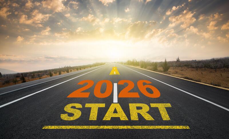 Concept for the start of the new year 2026. The word 2026 written on the asphalt road at sunrise. New calendar year change and anniversary concept