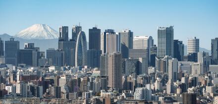 The view of the skyscrapers of Shinjuku and central Tokyo with the snow-covered peak of Mount Fuji in the distance.