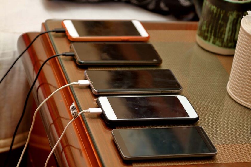 Five mobile phones are on charging at same time.