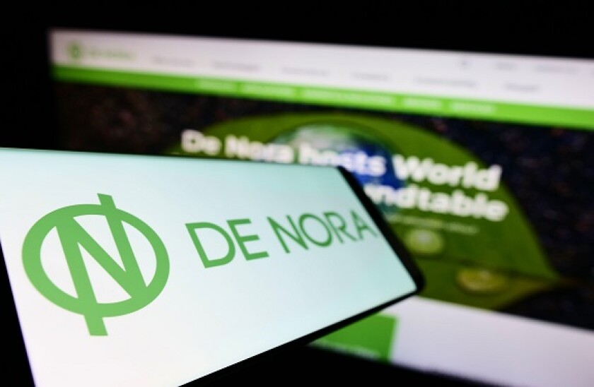 Smartphone with logo of Italian company Industrie De Nora S.p.A. on screen in front of business website. Focus on left of phone display.