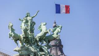 French flag and sculpture on top of  Grand Palais in Paris, France