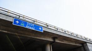 2035 Ahead Blue Road Sign Against Clear Sky