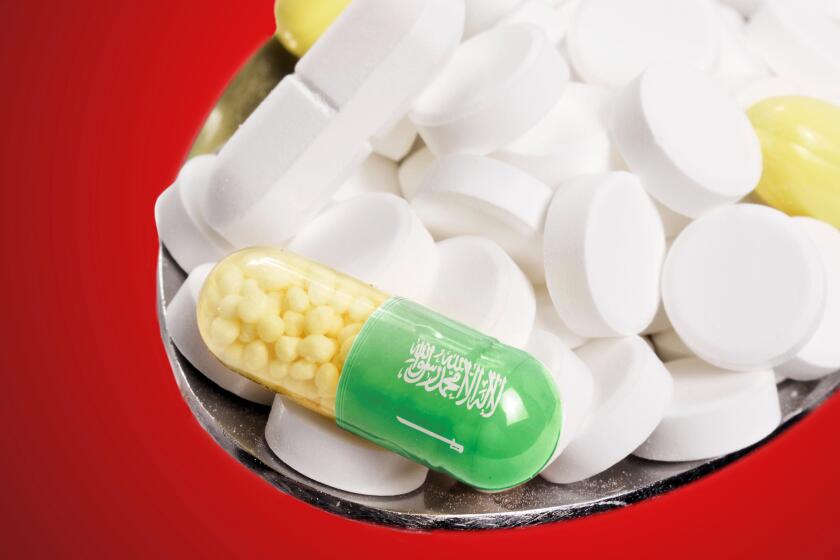 The national flag of Saudi Arabia on a capsule and pills on a spoon.(series)