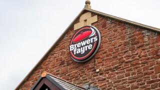 Logo sign for Brewers Fayre restaurant, above a food retail outlet, Prestwick, Scotland, UK