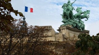 French flag and sculpture on the roof of Salon des Artistes Independants, Paris, France.