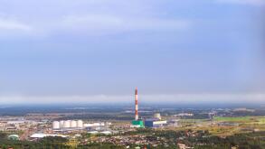 View from heights of Tallinn TV tower on Iru power plant, Eesti Energia. Types and horizons of Baltic cities with altitude. Cloudy overcast sky and ha