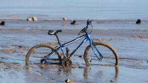 Bike stuck in river mud at New Brighton, Mereyside.