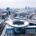 Brussels, Belgium - 8 February 2021: Aerial view of a European Union building under the snow at wintertime near Parque du Cinquantenaire.