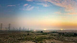 High voltage electric tower on sunrise time near Al Hofuf - Saudi Arabia.