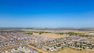 Aerial drone photo homes in Manor Texas neighborhoods growing