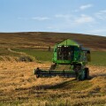 dh combine harvester HARVESTING UK John Deere Combine harvester cutting barley Orphir Orkney harvest fields scotland machinery farm machine. Image shot 2007. Exact date unknown.