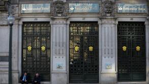 March 9, 2019 - Porto, Portugal - Men seen seating in front of Santander Totta bank..In 2018, Porto entered the list of the 100 most visited cities in the world in a ranking prepared by Euromonitor International. In 2018 it is estimated that the number of