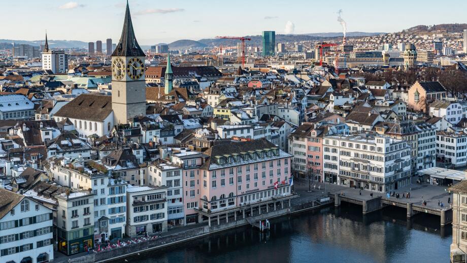 Zurich, Switzerland, Jan. 4, 2026. View of Zurich from Grossmunster tower showing the snowy rooftops, the Limmat river and the St. Peter church