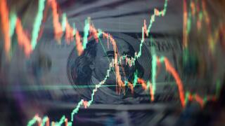 Charts of financial instruments with various type of indicators including volume analysis for professional technical analysis on the monitor of a comp