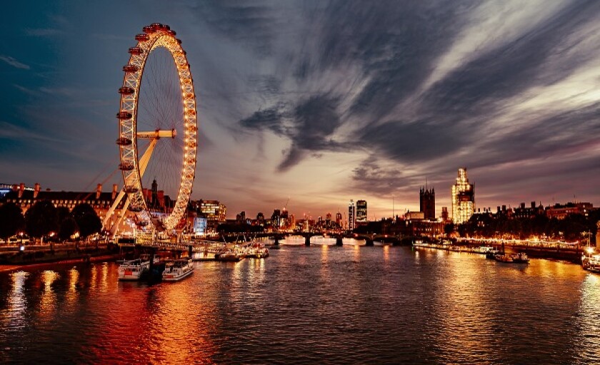 Ferris Wheel In City At Sunset