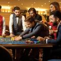 A group of people playing gambling in a casino.