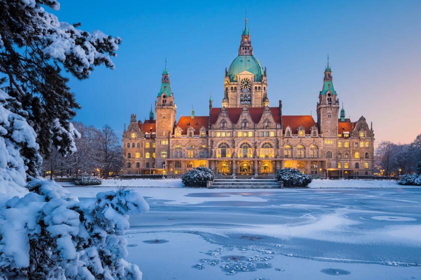 City Hall of Hannover, Germany in winter with snow and frozen lake