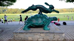 Runners near the Tortoise and Hare statue at Van Cortlandt Park