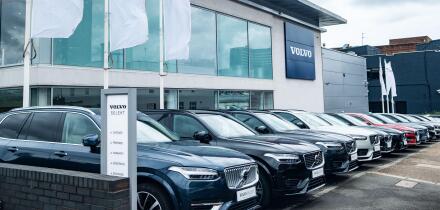 LONDON- JULY 31, 2023: Volvo car dealership-cars parked outside showroom with Volvo logo above. Swedish vehicle manufacturer.