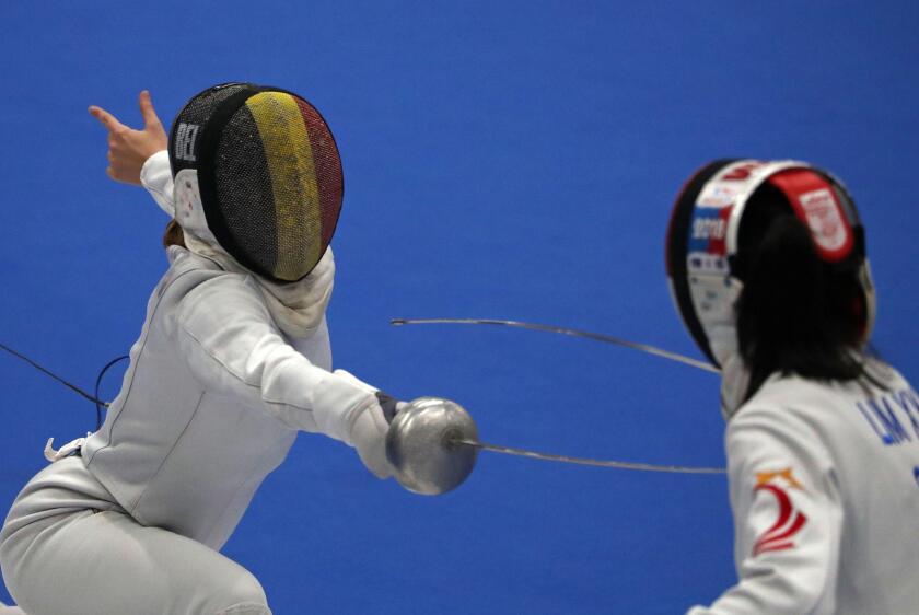 Aube Vandingenen, from Belgium, and Victoria Ann Xiu Yan Lim, from Singapore, during the 55th International Ciutat de Barcelona World Cup Womens Epee Fencing tournament, in Barcelona, on 11th February 2022. (Photo by Joan Valls/Urbanandsport /NurPhoto)