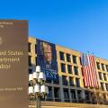 United States Department of Labor headquarters in Washington, DC, with banners of Donald Trump and Theodore Roosevelt reading "American Workers First"