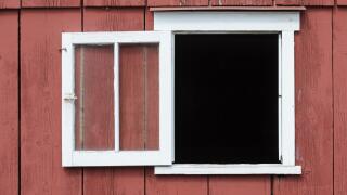 Open window in red barn with white trim as a design element, place your own image in the opening.