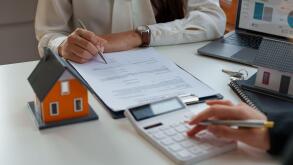 Real estate brokers calculation for loan rating and advise customers to sign their names. Real estate agent, property broker, real estate investment