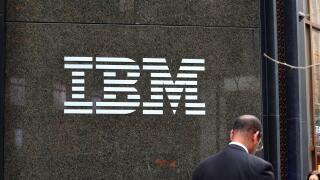 A businessman walks past the IBM building at 590 Madison Ave, New York in Midtown Manhattan.