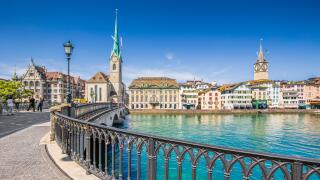 Historic city center of Zurich with famous Fraumunster Church and Munsterbucke crossing river Limmat, Canton of Zurich, Switzerland