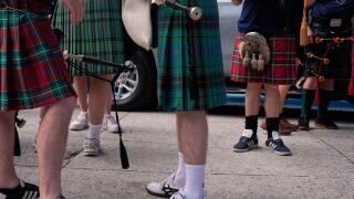 Scotland soccer fans with bagpipes wear kilts as they wait to enter the stadium for a Miami Marlins against the Texas Rangers baseball game after marching with the Tartan Army, Monday, June 22, 2026, in Miami. (AP Photo/Rebecca Blackwell)