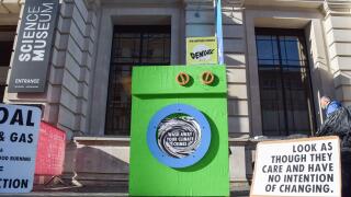 London, UK. 24th Oct, 2021. A 'greenwashing machine' and placards are seen during the protest outside the Science Museum. Extinction Rebellion activists gathered outside the museum in South Kensington in protest against the museum's 'greenwash' sponsorshi