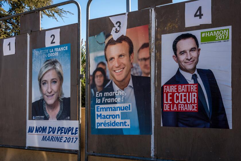 posters of french presidential elections candidates of Benoit Hamon, Emmanuel Macron and Marine le Pen.