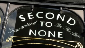 ' Second to None Guaranteed to be the Best ' sign on shop window